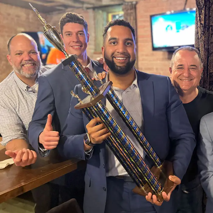 Friends holding the trivia trophy book a private trivia or music bingo event with hudson valley trivia co